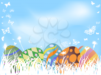 the background of color painted easter eggs hiding in grass 	