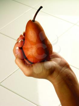 Royalty Free Photo of a Hand Holding a Pear