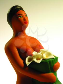 Royalty Free Photo of a Figurine of a Naked Woman With Flowers