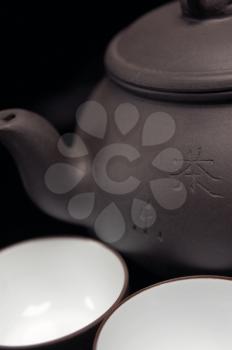 chinese jasmine tea pot and cups over black