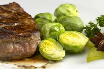 juicy filet mignon on plate with brussel sprout