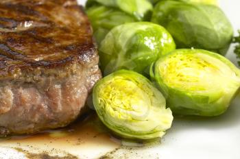 juicy filet mignon on plate with brussel sprout
