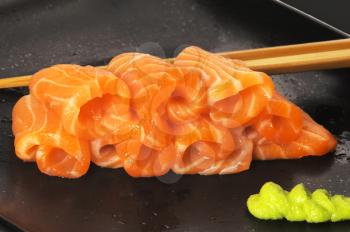 slice of salmon sushi with wasabi sauce