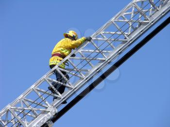 Royalty Free Photo of a Fireman Climbing a Ladder