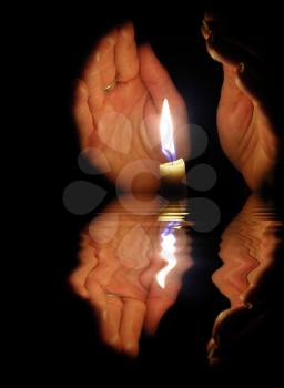 Royalty Free Photo of Hands Around a Candle