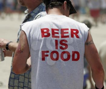 Royalty Free Photo of a Man Wearing a Beer is Food Shirt