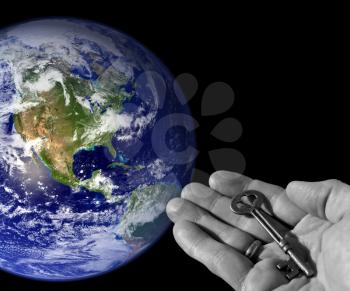 Royalty Free Photo of a Person Holding a Skeleton Key by Earth