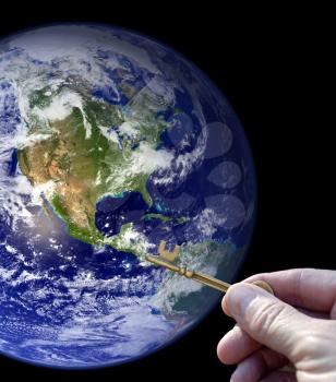 Royalty Free Photo of a Person Holding the Key to Earth