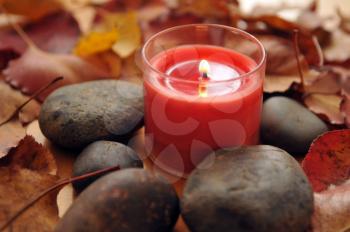 Royalty Free Photo of a Candle and Stones