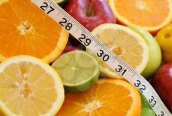 Royalty Free Photo of Fruit and a Measuring Tape