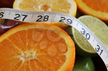 Royalty Free Photo of Fruits and Measuring Tape