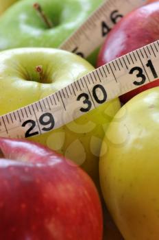 Royalty Free Photo of Apples and Measuring Tape