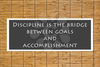 Royalty Free Photo of a Discipline Quote Over a Bamboo Background