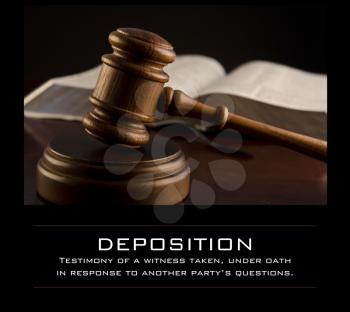 Royalty Free Photo of a Gavel and a Book With a Definition of Deposition
