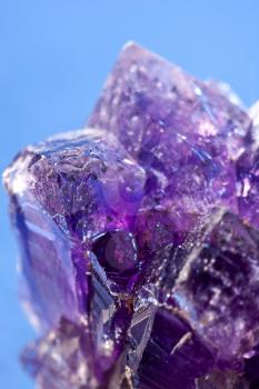 Royalty Free Photo of a Purple Amethyst Against Blue