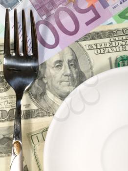 Royalty Free Photo of a Money Background With a Plate and Fork
