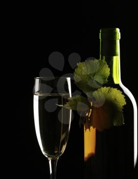 Royalty Free Photo of a Wine Bottle and Glass on Black