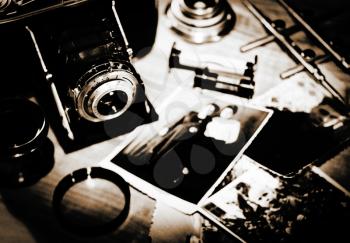 Still life. Vintage stylized lithprint with retro photo camera and old photos