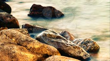 Sleeping sea with coastal rocks, abstract natural landscape
