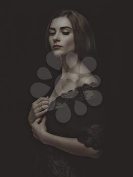 Dramatic female portrait against dark backgrounds