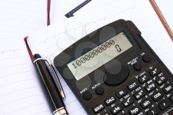 Royalty Free Photo of a Calculator on a Notebook