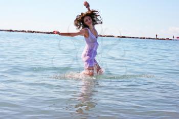 Royalty Free Photo of a Woman Dancing in the Sea