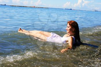 Royalty Free Photo of a Woman Sitting in the Sea