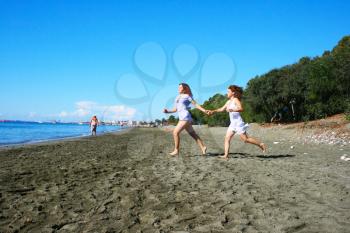 Royalty Free Photo of Two Women Running on the Beach 
