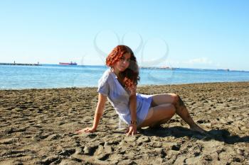 Royalty Free Photo of a Woman Sitting on the Beach