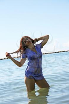 Royalty Free Photo of a Woman Standing in the Sea