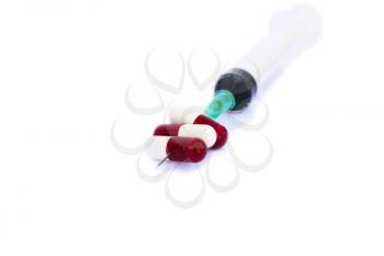 Royalty Free Photo of a Syringe and Pills