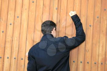 Royalty Free Photo of a Man Knocking on Wood