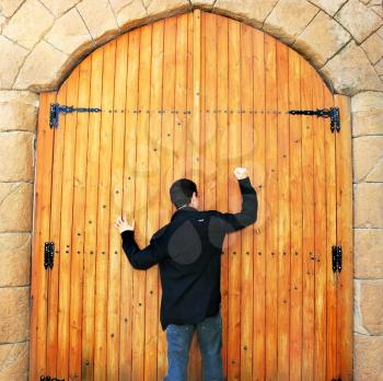 Royalty Free Photo of a Man Knocking on a Door