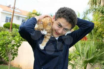Royalty Free Photo of a Teenage Boy Holding a Cat