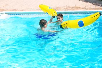 Royalty Free Photo of a Couple Playing in a Swimming Pool