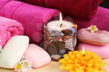 Royalty Free Photo of Soap and Candles by Towels
