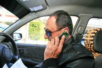 Royalty Free Photo of a Man Driving and Talking on a Cellphone
