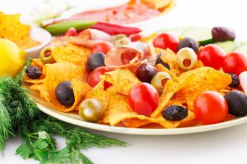 Nachos, olives, pork loin and vegetables image.