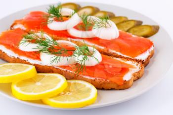 Royalty Free Photo of Smoked Salmon on Bread With Lemons and Pickles
