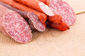 Fresh sausages on canvas background.