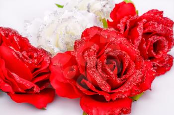Red and white fabric roses closeup picture.