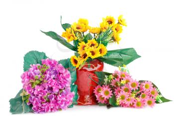 Yellow fabric flowers in vase and pink flowers isolated on white background.