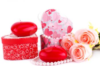 Red heart candles, roses, necklace and gift boxes on white background.