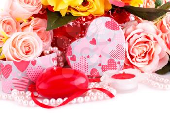 Colorful roses, candles, beads and gift box close up picture.