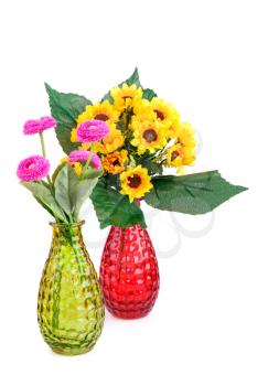 Pink and yellow fabric flowers in vases isolated on white background.