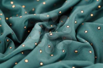 Green fabric background closeup picture.