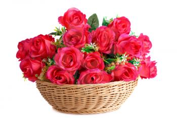 Red fabric roses in wicker basket isolated on white background.