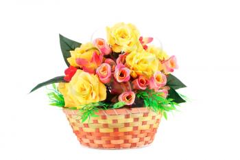 Colorful fabric roses in wicker basket isolated on white background.