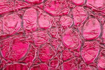 Pink leather background closeup picture.