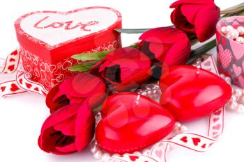 Red heart candles, tulips, necklaces and gift boxes on white backgroound.